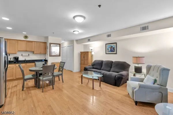 a living room with furniture and view of kitchen