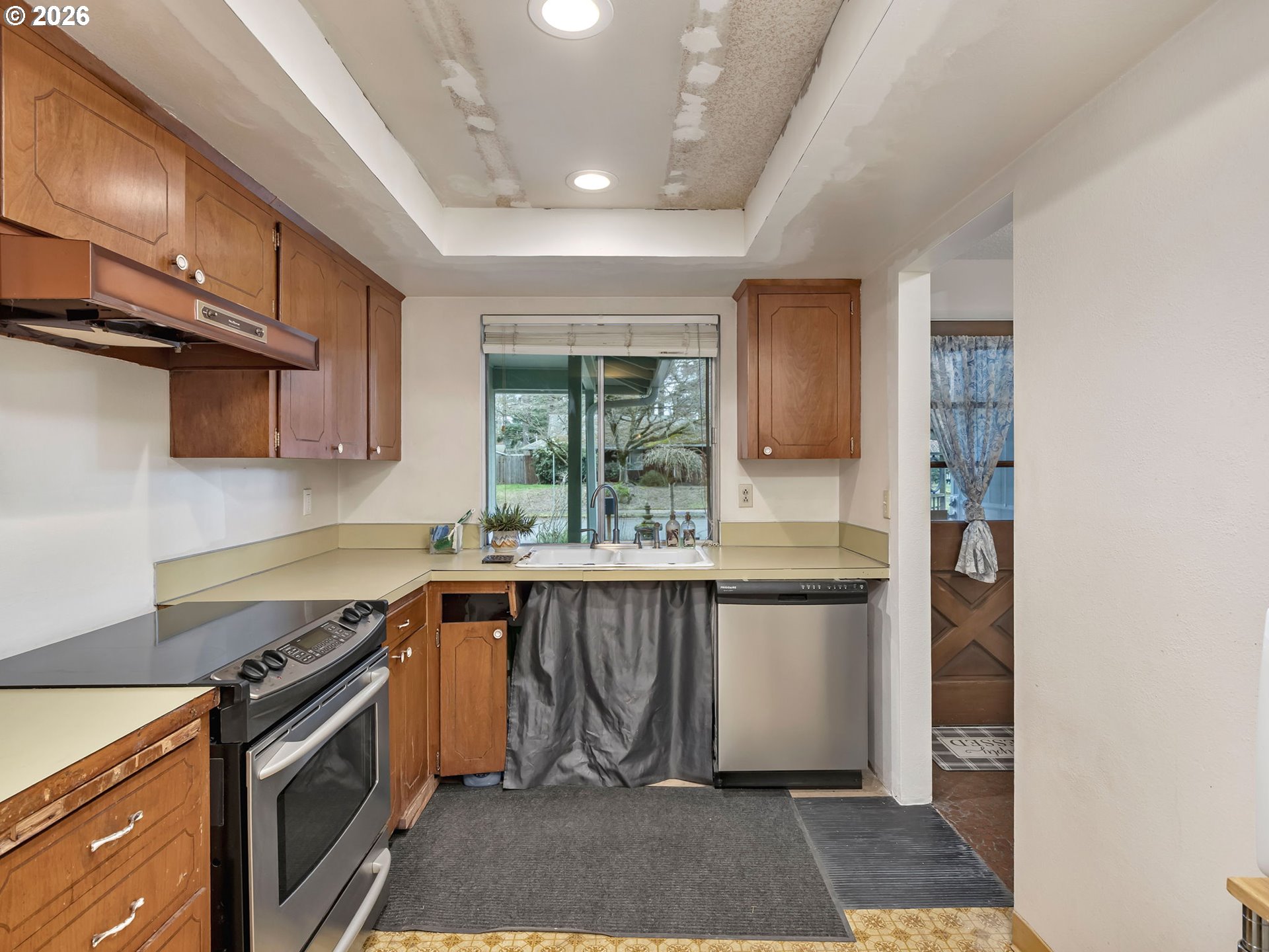 1033 Northeast 178th Avenue Portland, OR 97230 - Photo 12 of 29 a kitchen with stainless steel appliances granite countertop a stove a sink and a microwave