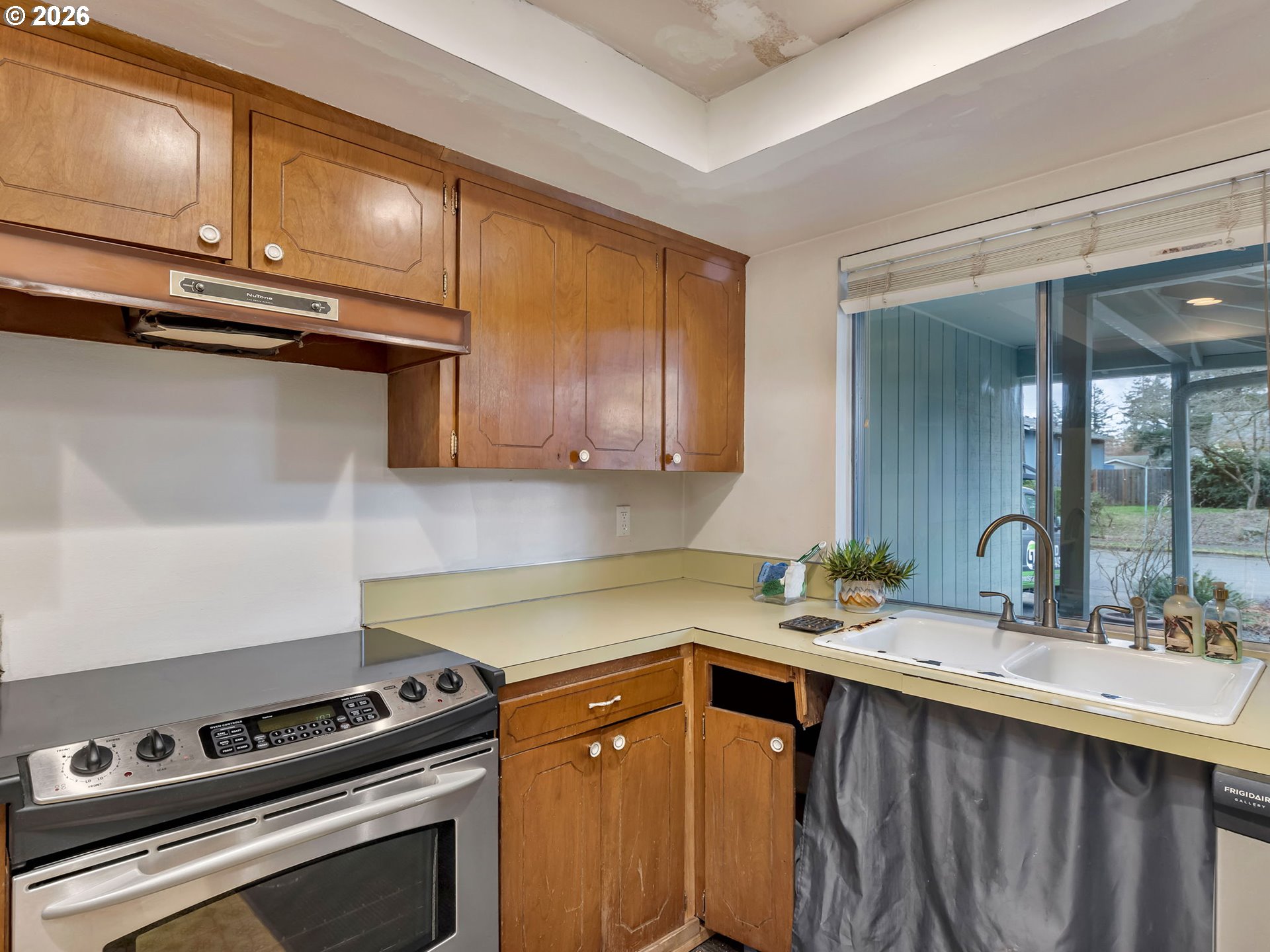 1033 Northeast 178th Avenue Portland, OR 97230 - Photo 13 of 29 a kitchen with stainless steel appliances a sink dishwasher stove and cabinets