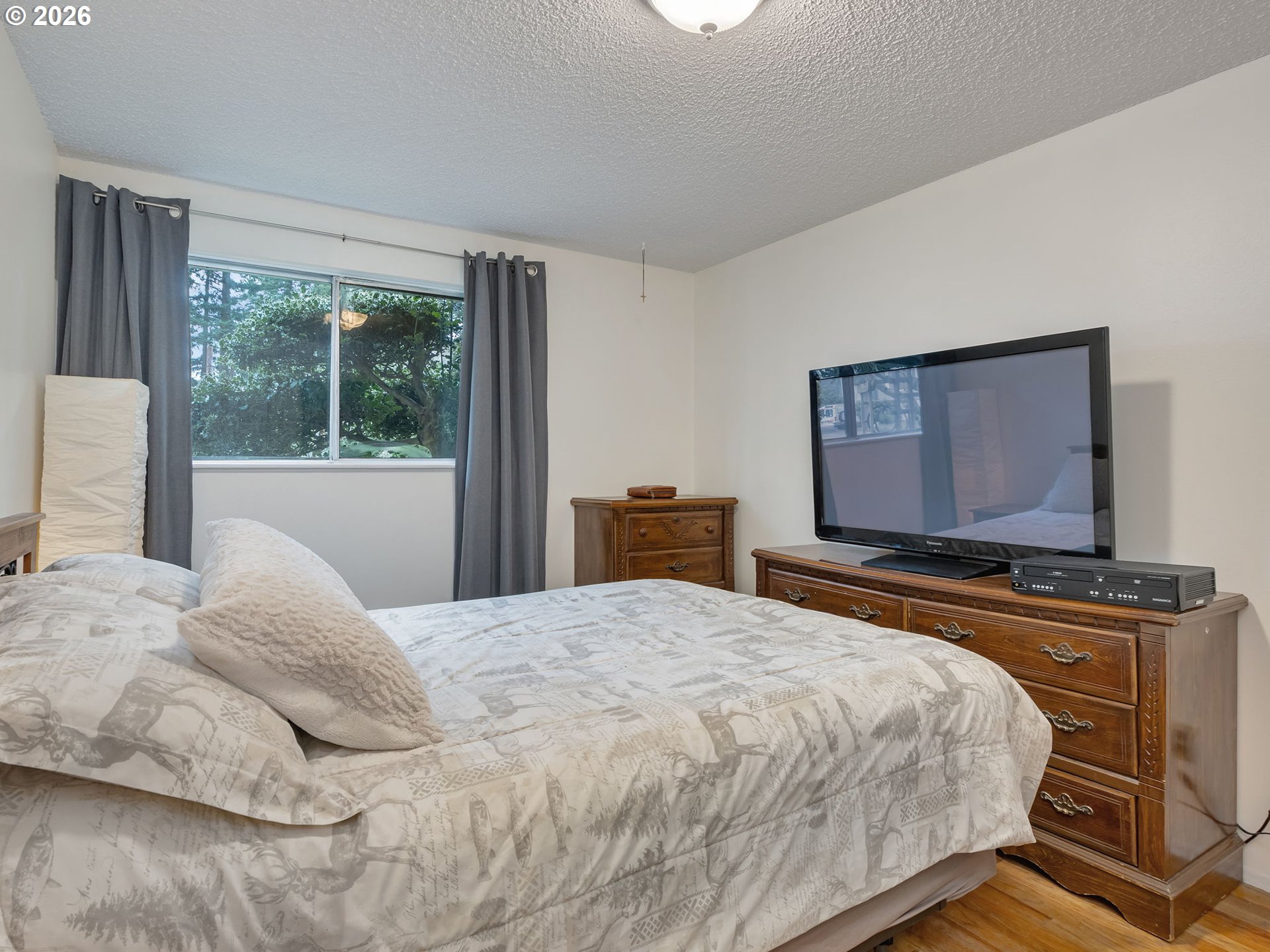 1033 Northeast 178th Avenue Portland, OR 97230 - Photo 16 of 29 a bedroom with a bed and a flat tv screen on dresser