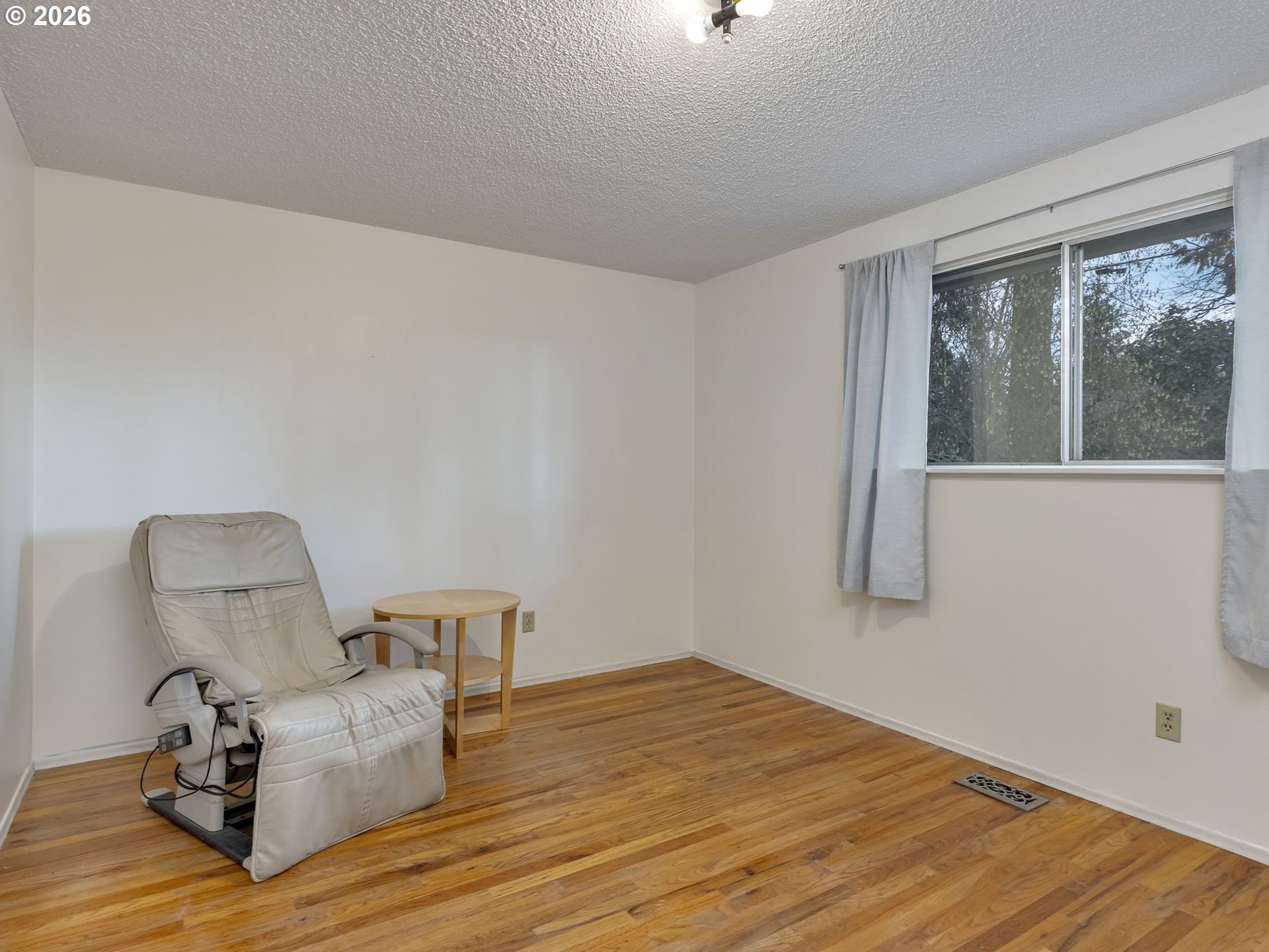 1033 Northeast 178th Avenue Portland, OR 97230 - Photo 19 of 29 a room with chair and wooden floor
