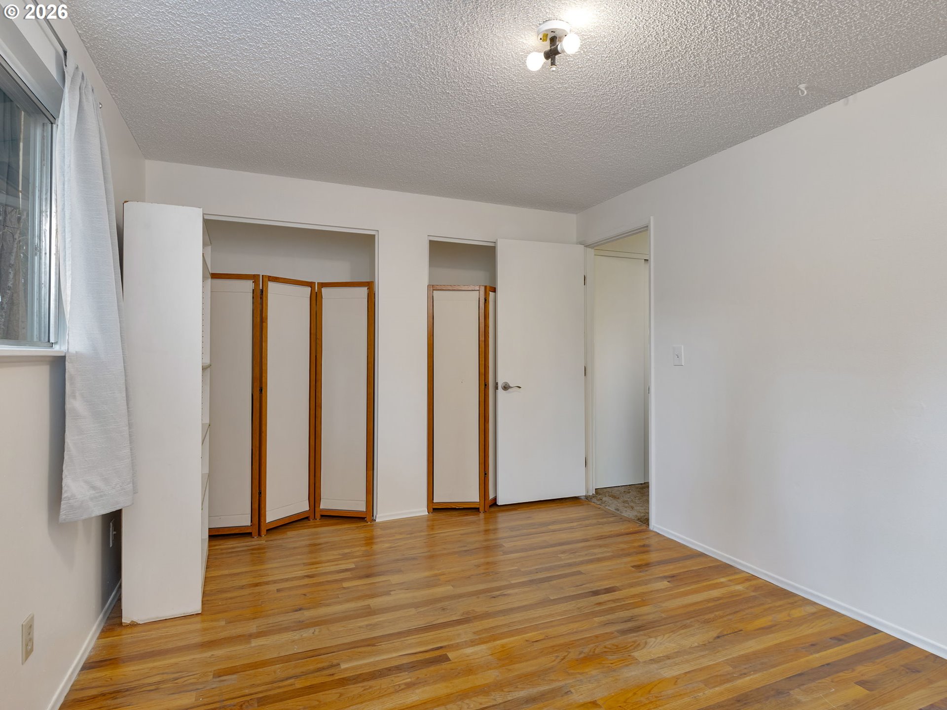 1033 Northeast 178th Avenue Portland, OR 97230 - Photo 20 of 29 a view of an empty room with wooden floor and closet