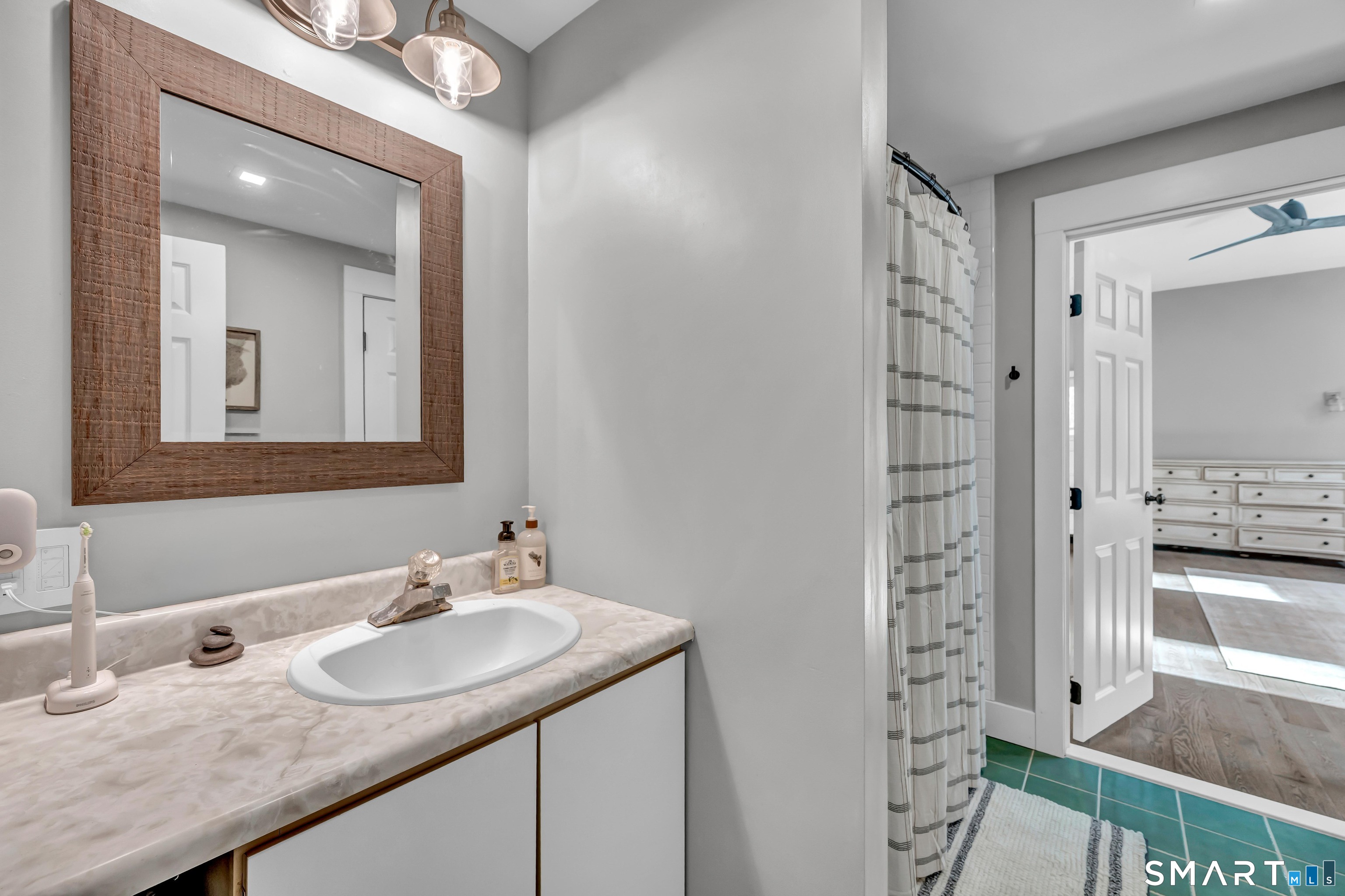 10 Grove Place Bethel, CT 06801 - Photo 19 of 33 a bathroom with a granite countertop sink and a mirror