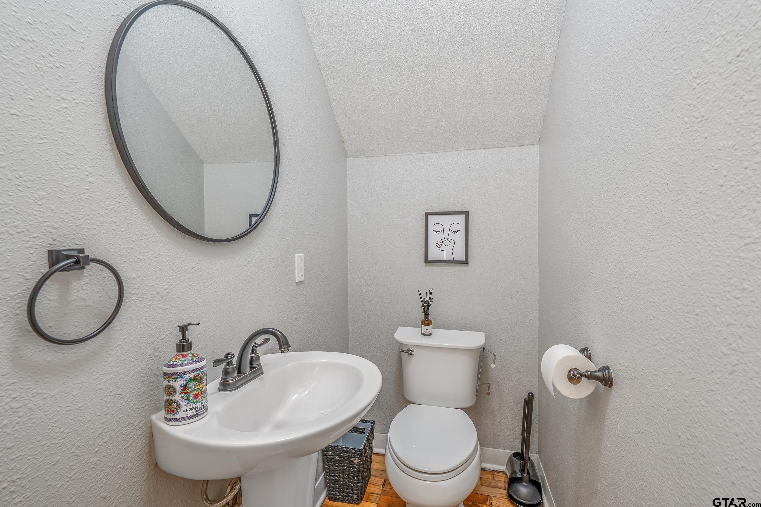 434 South Vine Avenue Tyler, TX 75702 - Photo 13 of 29 a bathroom with a toilet a sink and mirror