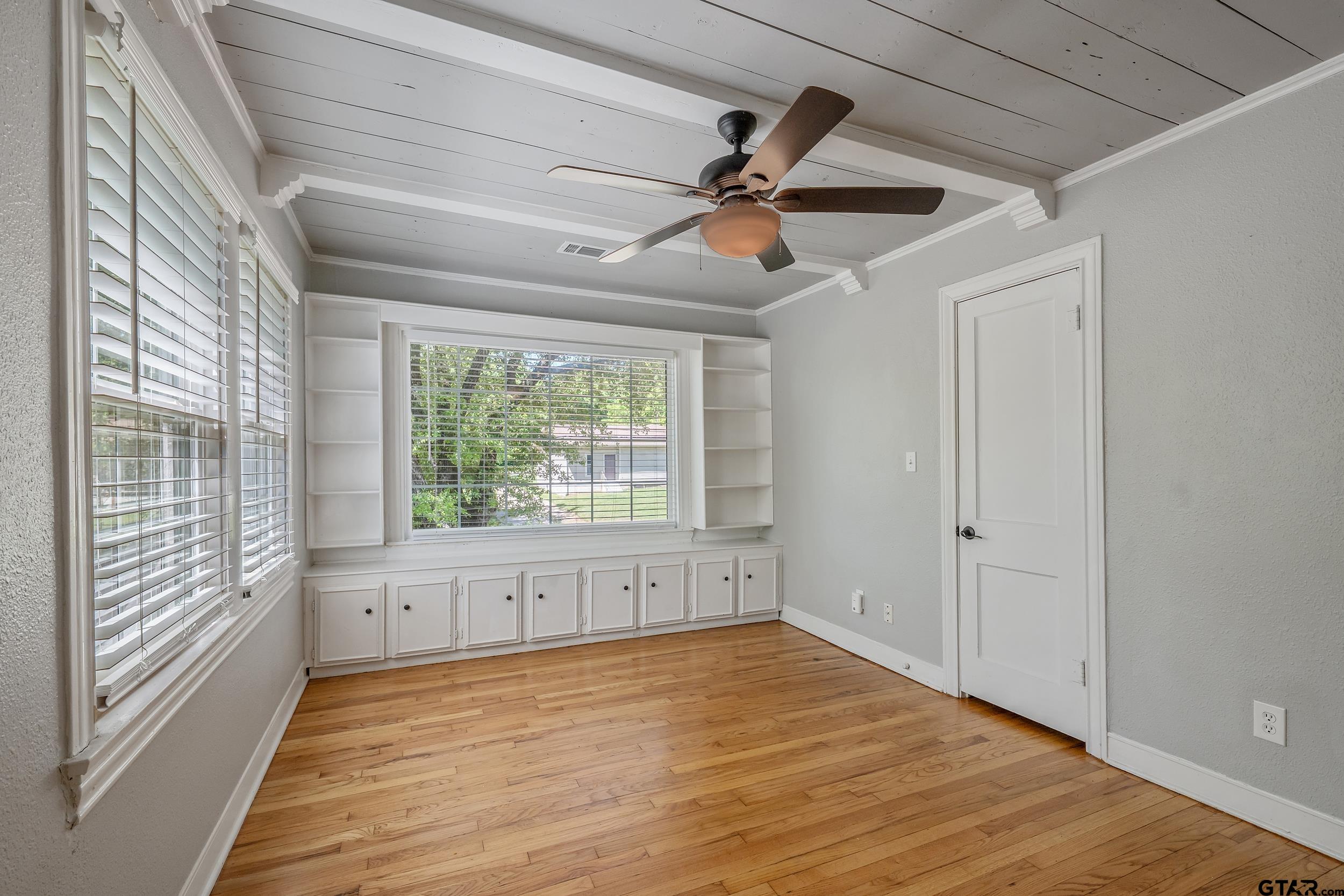 434 South Vine Avenue Tyler, TX 75702 - Photo 15 of 29 a view of an empty room with wooden floor and a window