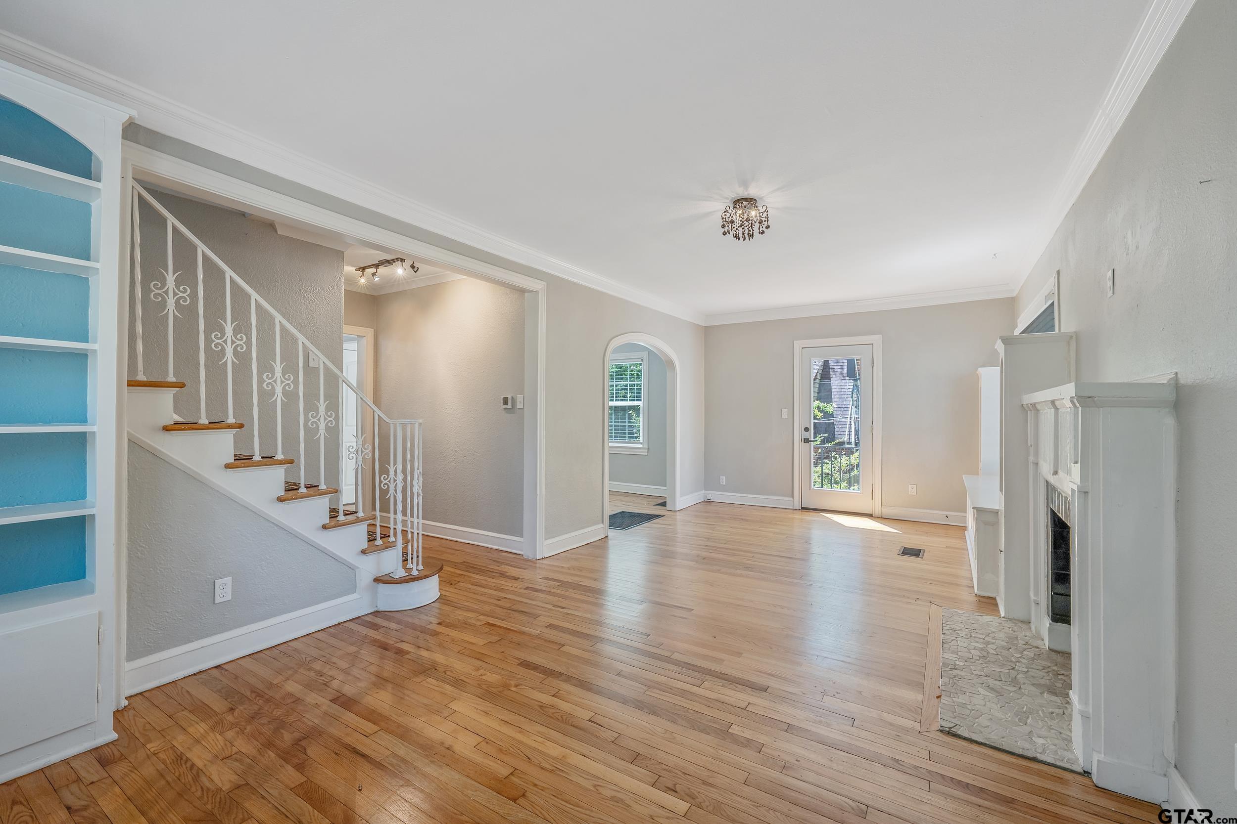 434 South Vine Avenue Tyler, TX 75702 - Photo 3 of 29 a view of an empty room with wooden floor and a window
