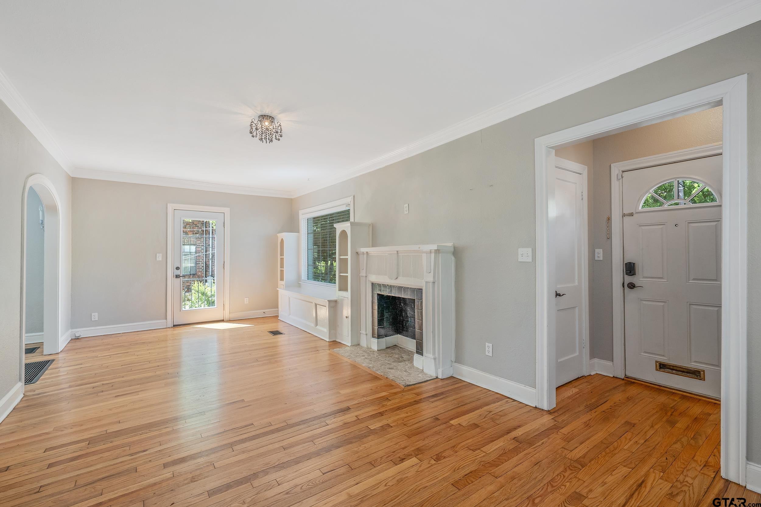 434 South Vine Avenue Tyler, TX 75702 - Photo 4 of 29 a view of an empty room with window and wooden floor