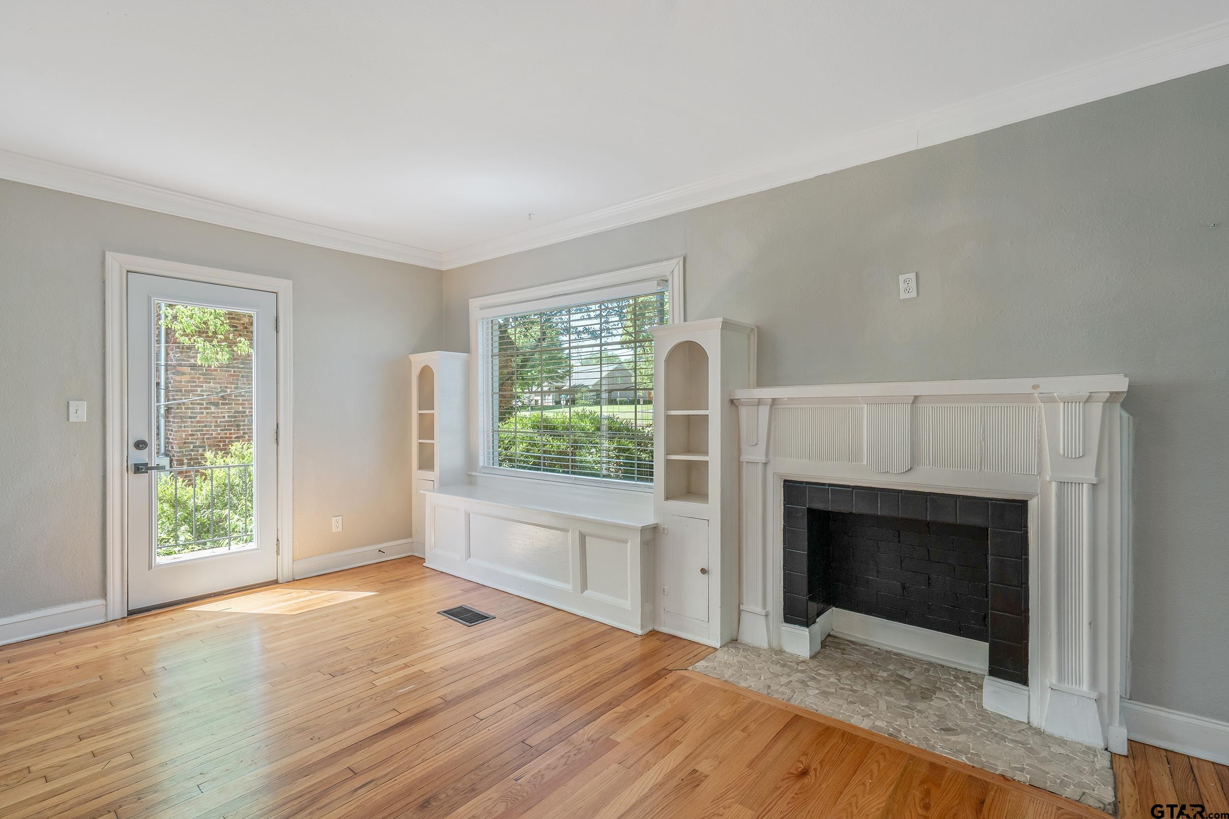 434 South Vine Avenue Tyler, TX 75702 - Photo 5 of 29 a bedroom with a bed and a fireplace