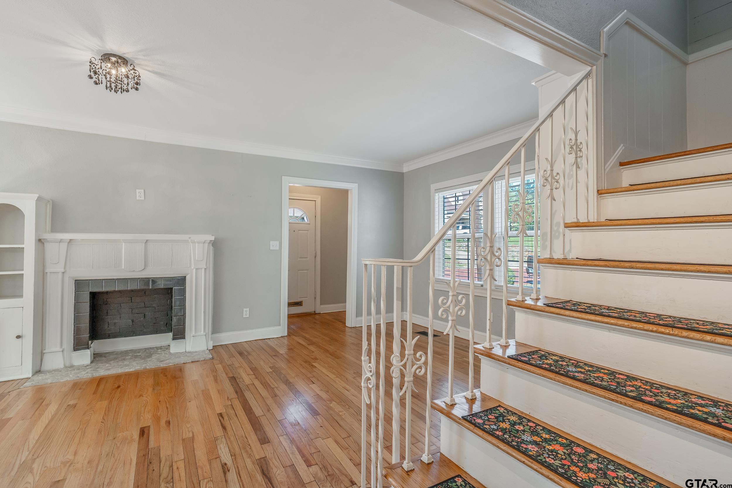 434 South Vine Avenue Tyler, TX 75702 - Photo 7 of 29 a view of an empty room with wooden floor fireplace and a window
