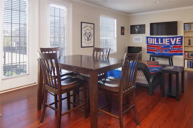 a view of a dining room with furniture window and wooden floor