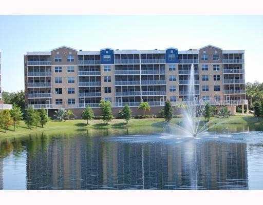 960 Starkey Road, Unit 1305 Largo, FL 33771 - Photo 1 of 1 a view of a tall building and a yard