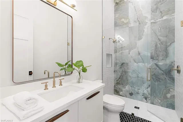 a bathroom with a sink toilet and shower