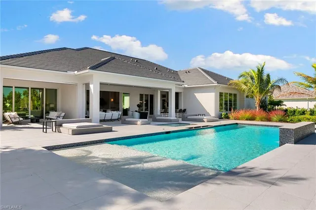 a view of yard with swimming pool and green space