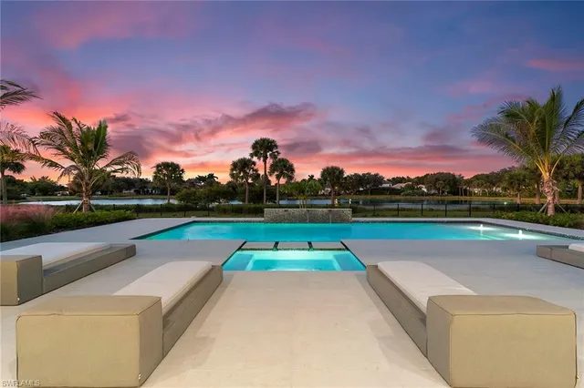 a view of swimming pool with outdoor seating and yard in back