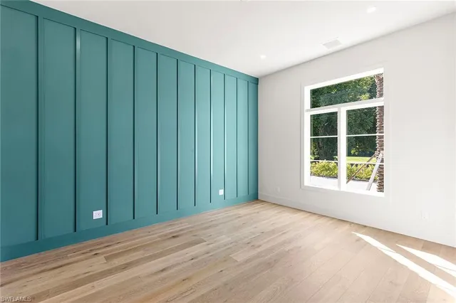 a bathroom with a sink and mirror with shower