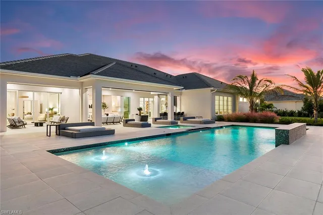 a swimming pool with outdoor seating and yard