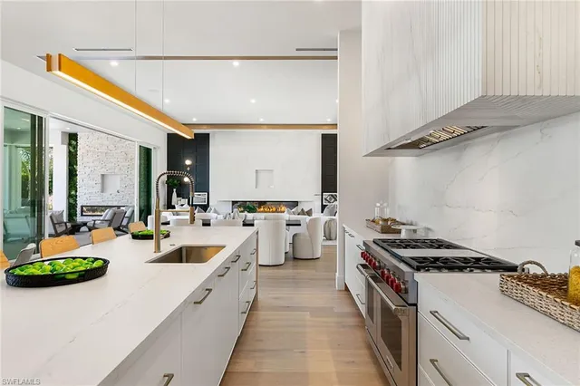 a kitchen with stove and white cabinets