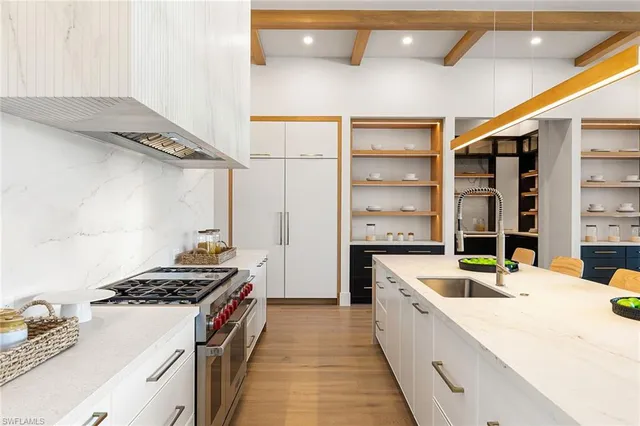 a kitchen with a stove a sink and a refrigerator