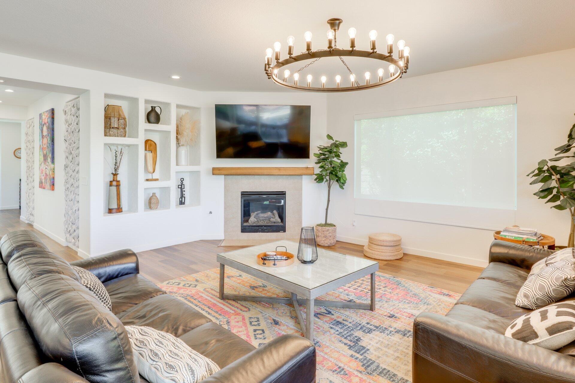 84644 Pavone Way Indio, CA 92203 - Photo 15 of 46 a living room with furniture a flat screen tv and a fireplace