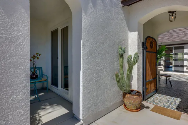 a bed sitting in a bedroom and a flat screen tv