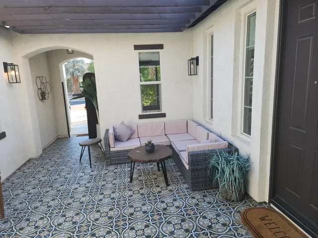 a view of a house with backyard porch and sitting area