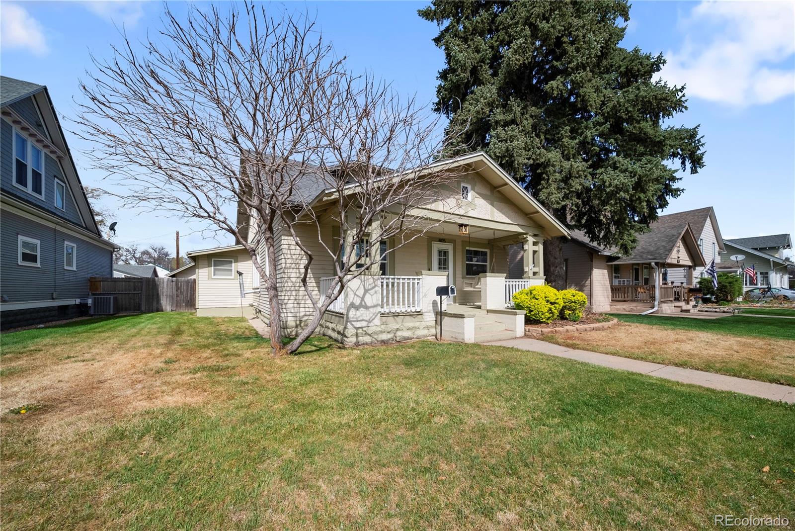 405 Maple Street Fort Morgan, CO 80701 - Photo 1 of 9 a view of a house with a yard and sitting area