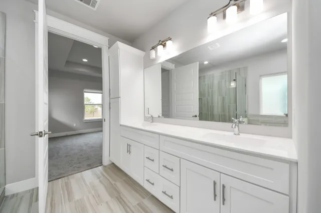 a bathroom with a double vanity sink and mirror