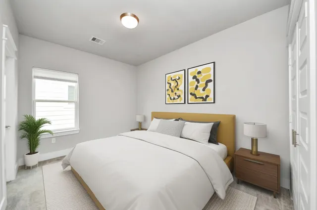 a bedroom with a bed and a potted plant