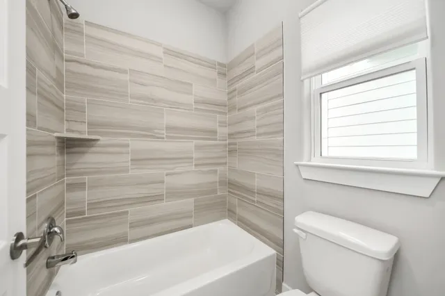 a bathroom with a toilet a sink and bathtub