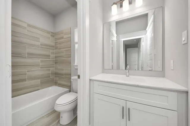 a view of a house with backyard and wooden fence