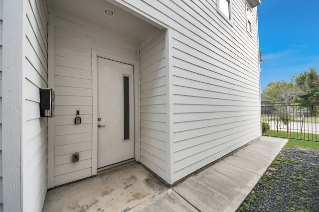 a view of a porch with wooden floor and fence