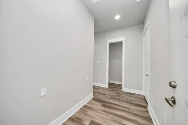 a view of a room with wooden floor