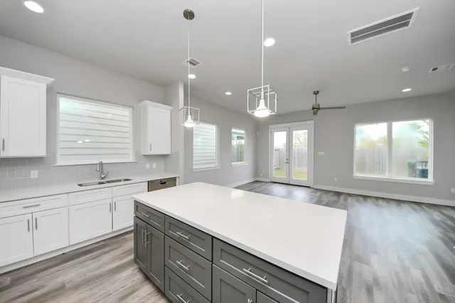 a large kitchen with kitchen island a sink stainless steel appliances and window