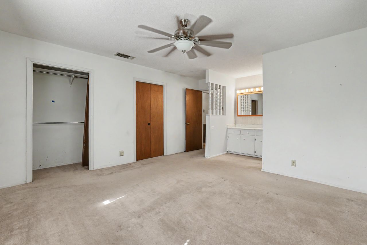 1811 Terry Lane Georgetown, TX 78628 - Photo 18 of 40 Well-lit primary bedroom featuring a ceiling fan and convenient walk-in closet space.