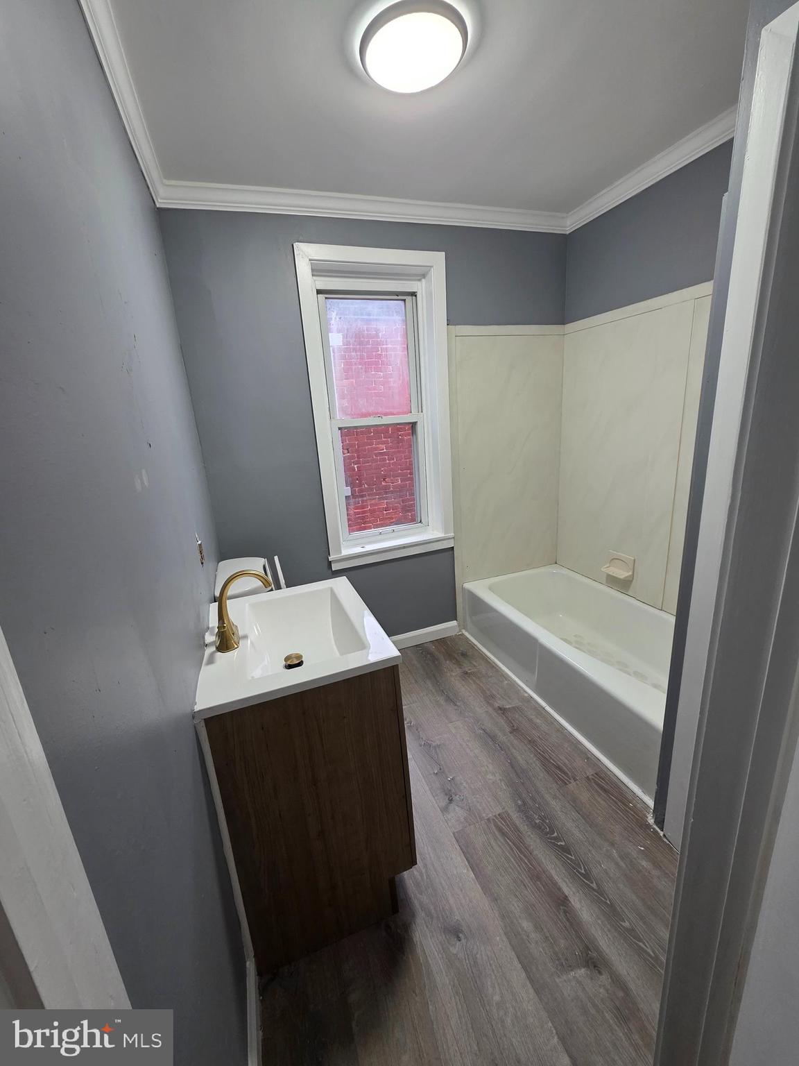 521 Birch Street Reading, PA 19604 - Photo 12 of 16 a bathroom with a tub sink and mirror