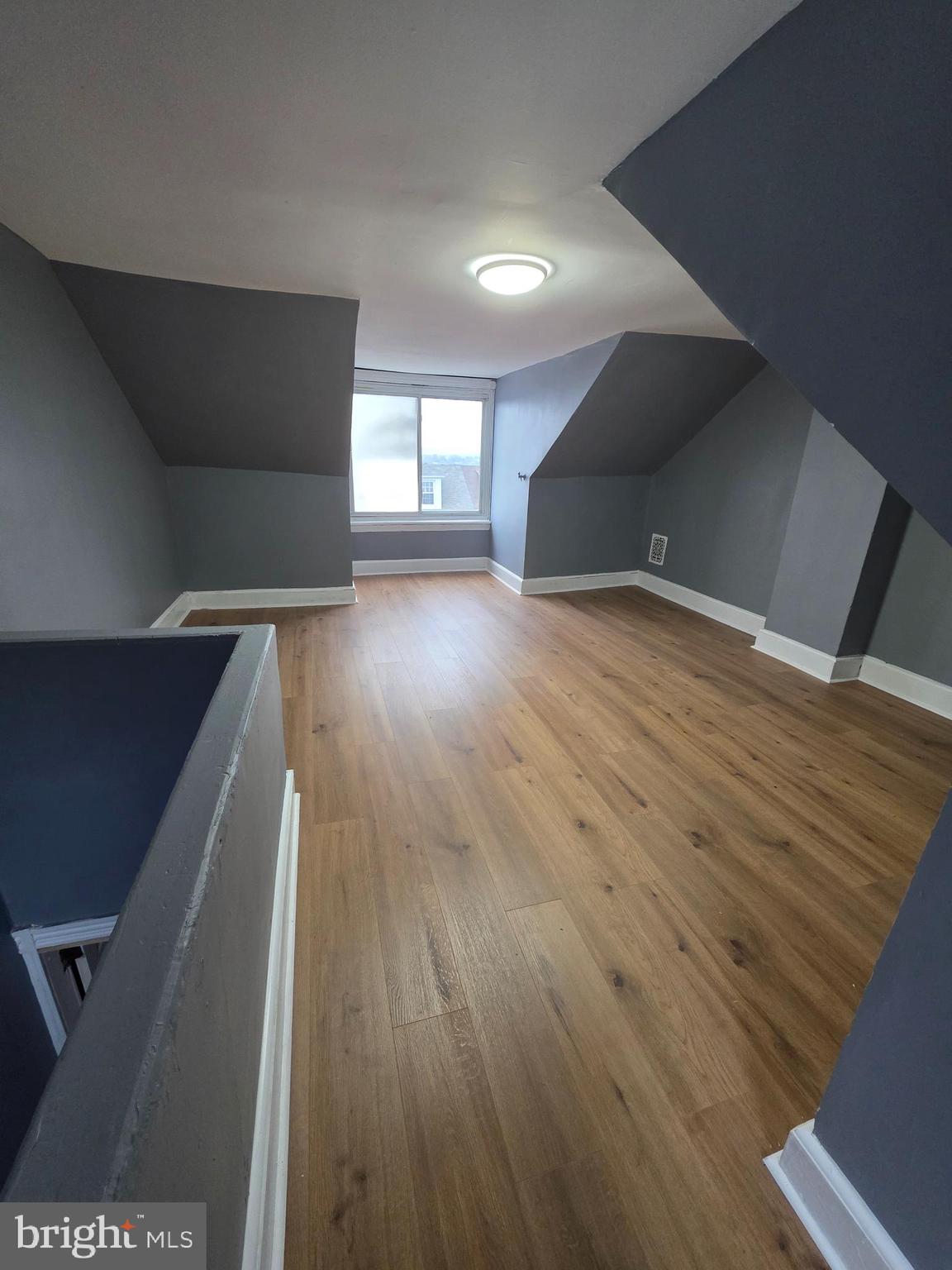 521 Birch Street Reading, PA 19604 - Photo 13 of 16 a view of an empty room with wooden floor and a window