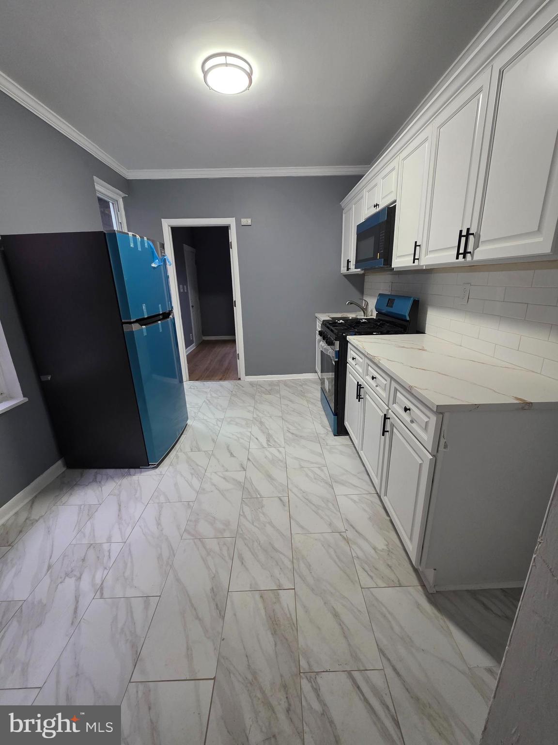 521 Birch Street Reading, PA 19604 - Photo 5 of 16 a kitchen with stainless steel appliances a refrigerator and a stove top oven