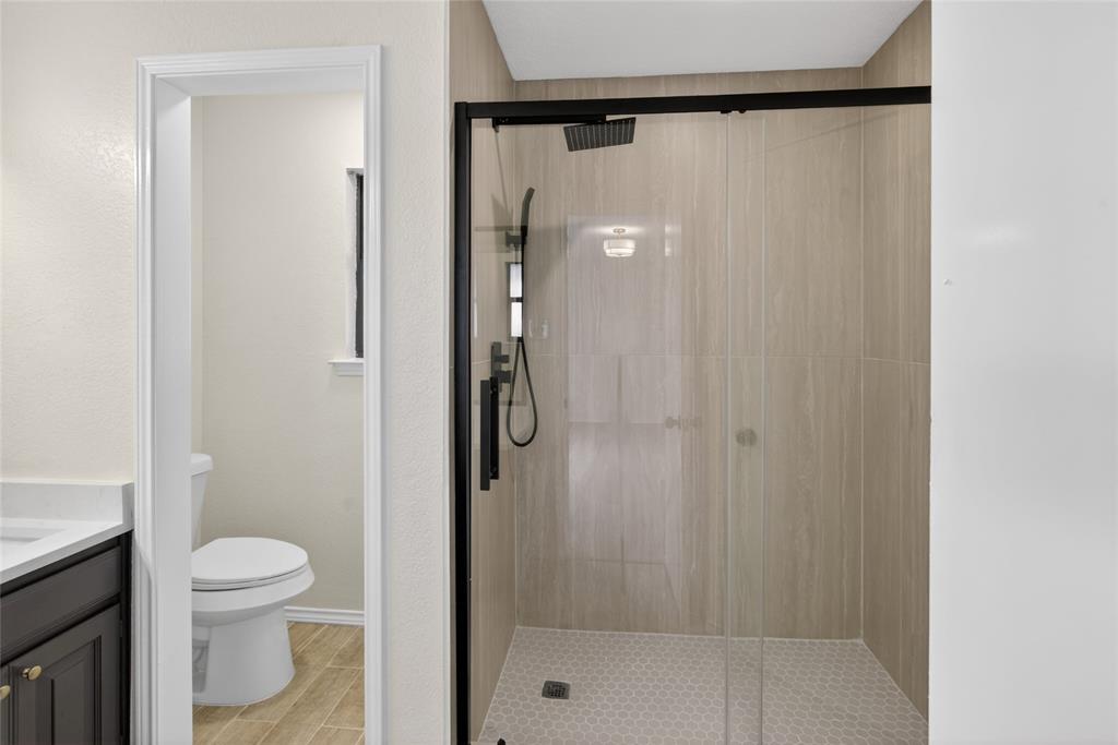 509 Brookside Court Burleson, TX 76028 - Photo 10 of 18 a bathroom with a shower and a toilet