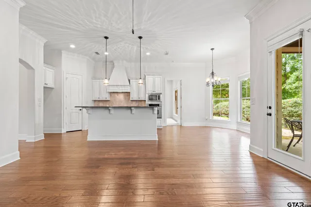 an open kitchen with kitchen island and stainless steel appliances