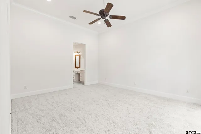 an empty room with closet and windows