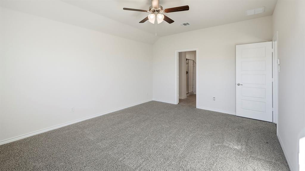403 Flintlock Road Caddo Mills, TX 75135 - Photo 18 of 26 Unfurnished bedroom with carpet floors, ceiling fan, and vaulted ceiling