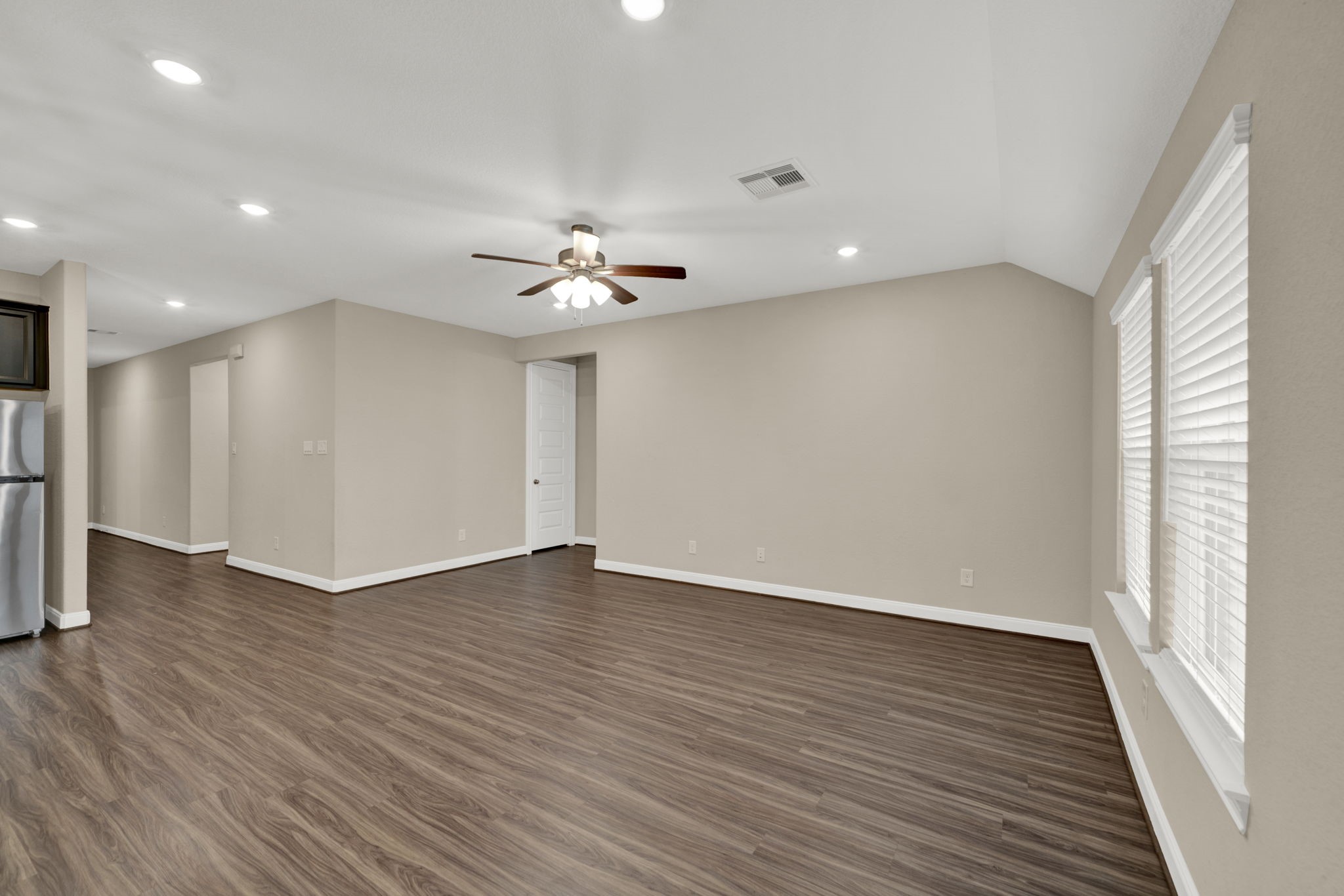 2217 Gadwall Court Conroe, TX 77384 - Photo 12 of 35 a view of an empty room with wooden floor and a window