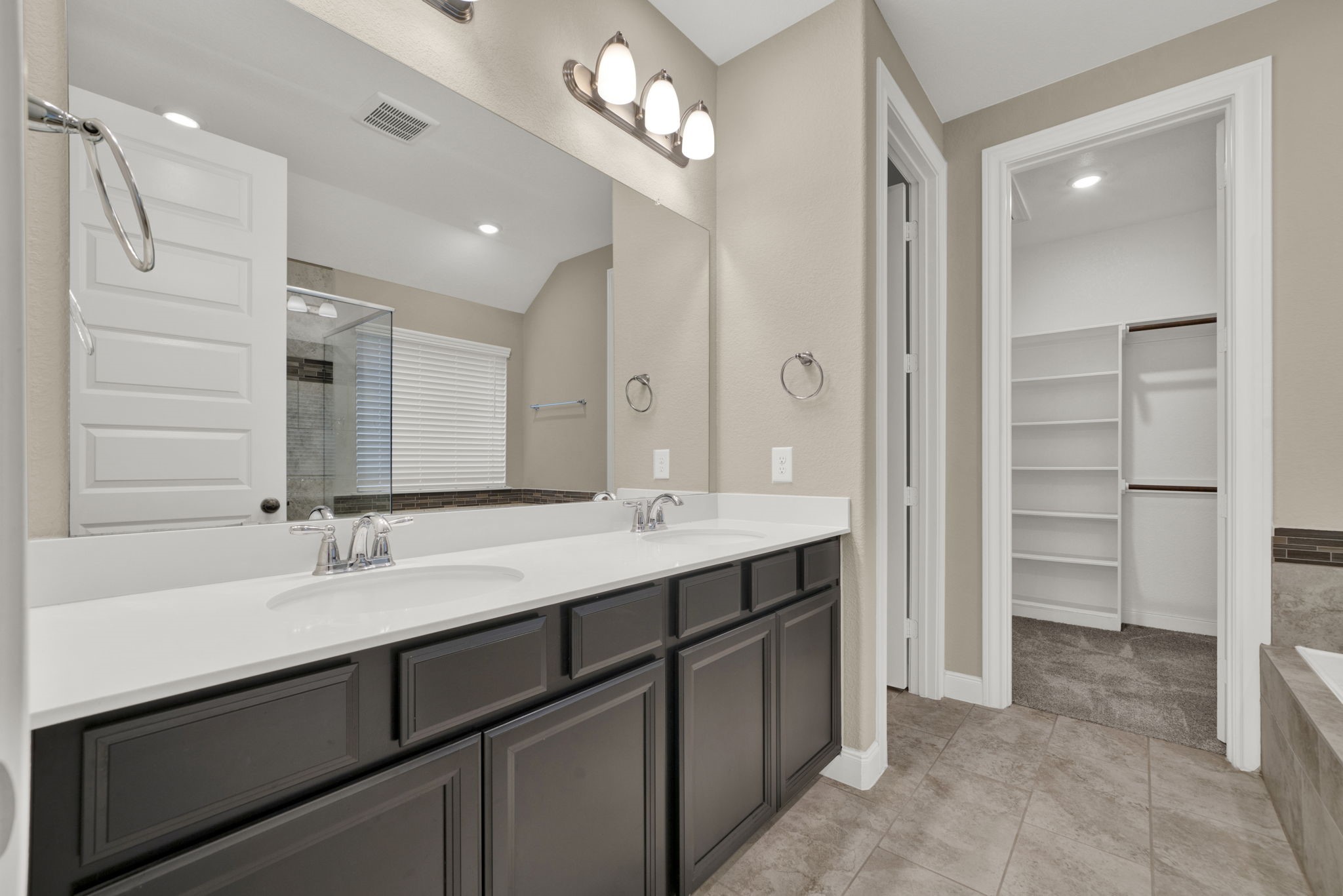2217 Gadwall Court Conroe, TX 77384 - Photo 16 of 35 a bathroom with a sink double vanity and a shower