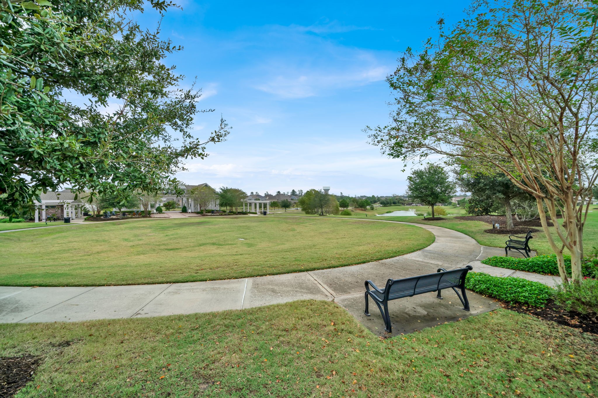 2217 Gadwall Court Conroe, TX 77384 - Photo 26 of 35 a view of a lake with a garden and outdoor seating