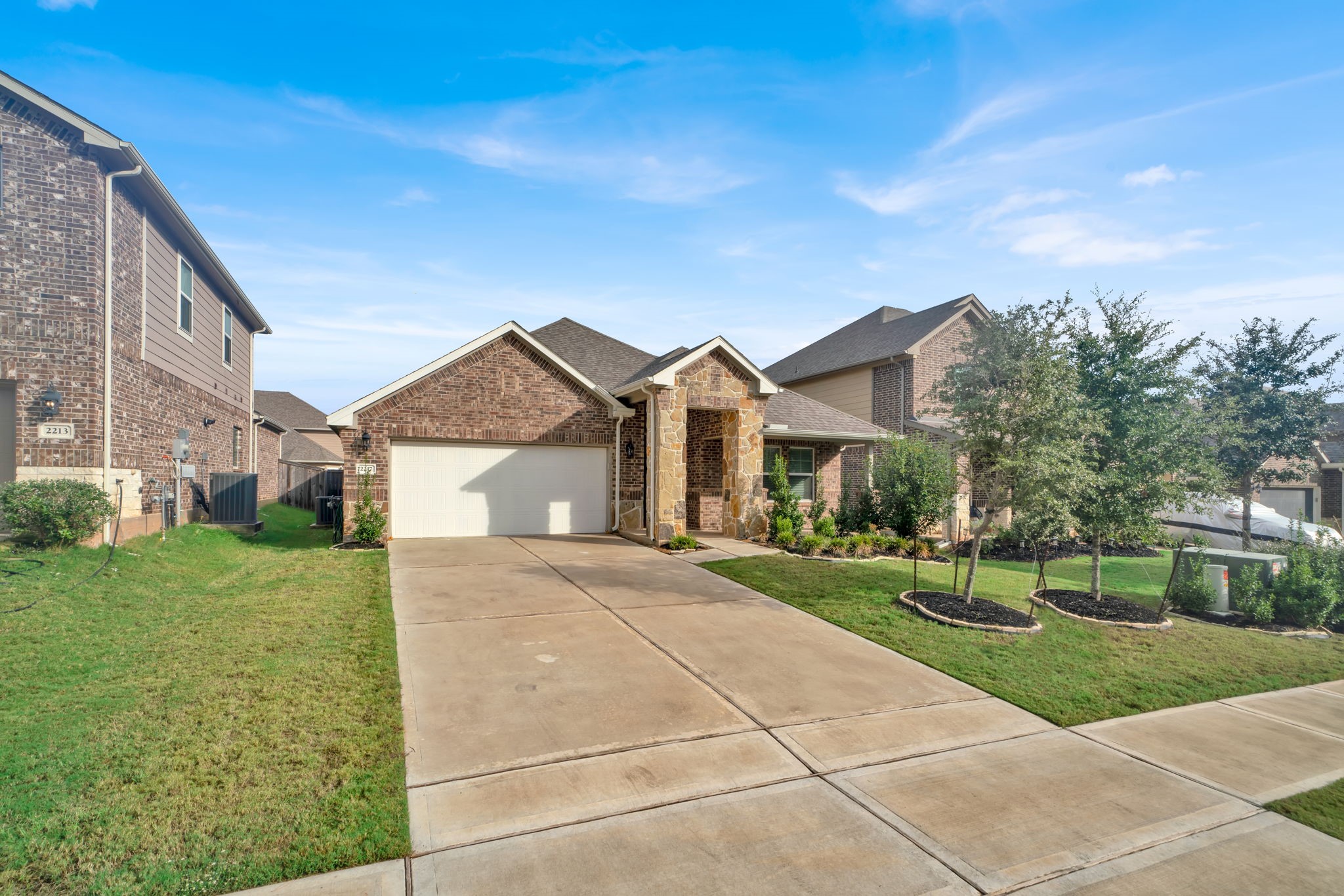 2217 Gadwall Court Conroe, TX 77384 - Photo 3 of 35 a front view of a house with a yard and garage