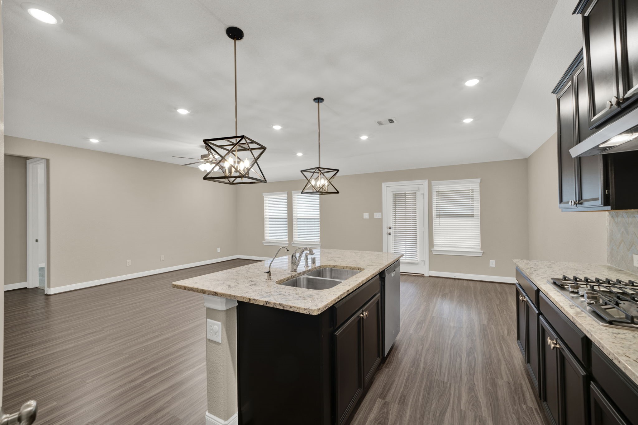 2217 Gadwall Court Conroe, TX 77384 - Photo 7 of 35 a kitchen with sink microwave and stove