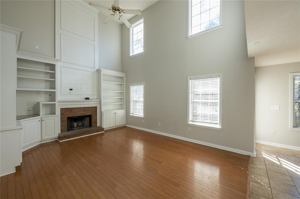 3789 Seattle Place Northwest Kennesaw, GA 30144 - Photo 13 of 40 wooden floor fireplace and windows in an empty room