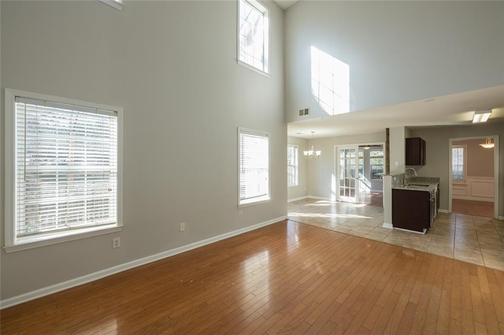 3789 Seattle Place Northwest Kennesaw, GA 30144 - Photo 14 of 40 a view of an empty room with wooden floor and a window