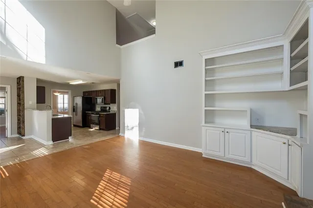 a view of a kitchen with furniture and wooden floor