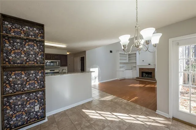 a view of a kitchen with cabinet and refrigerator